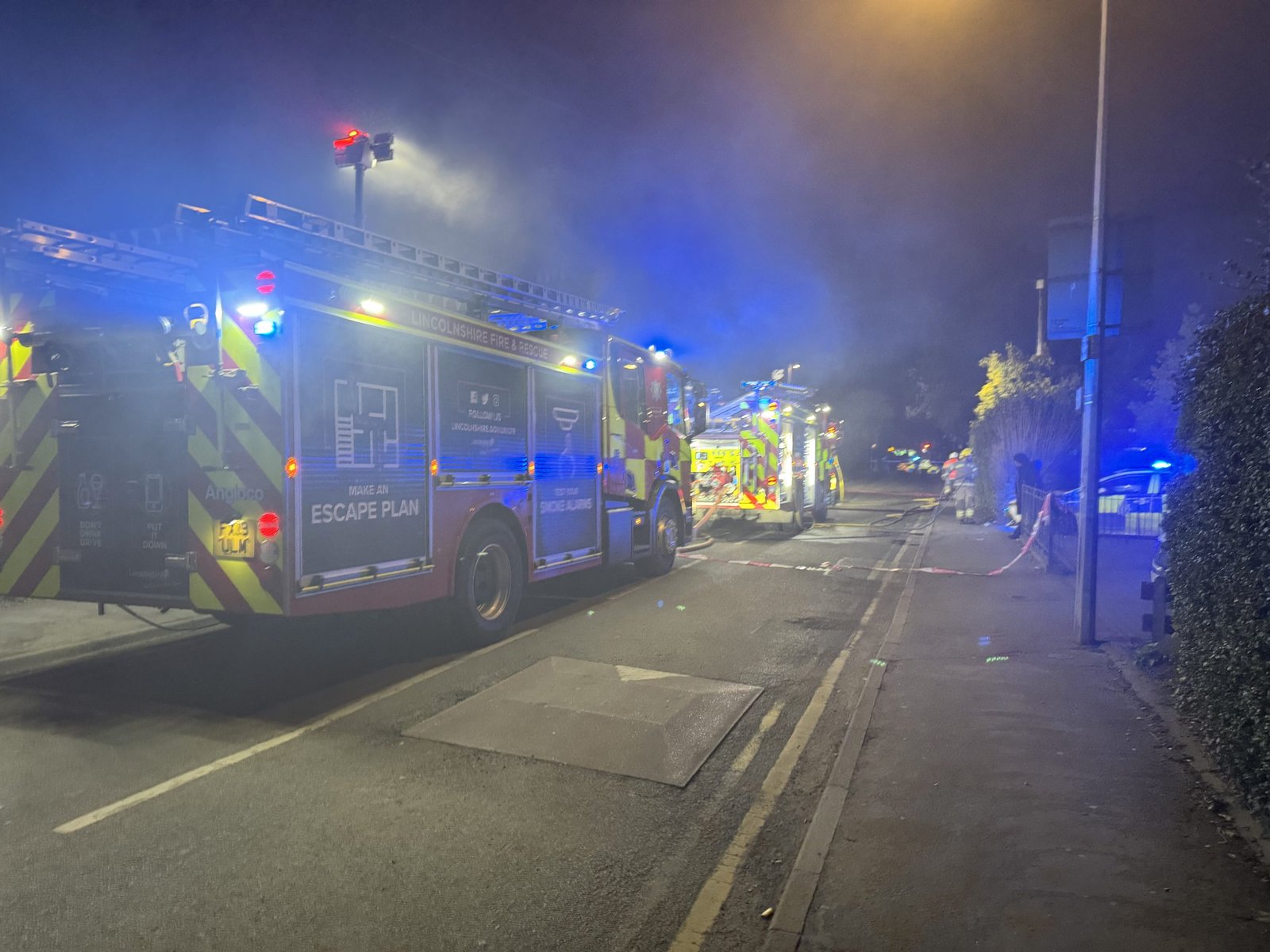 Large house fire closes busy street